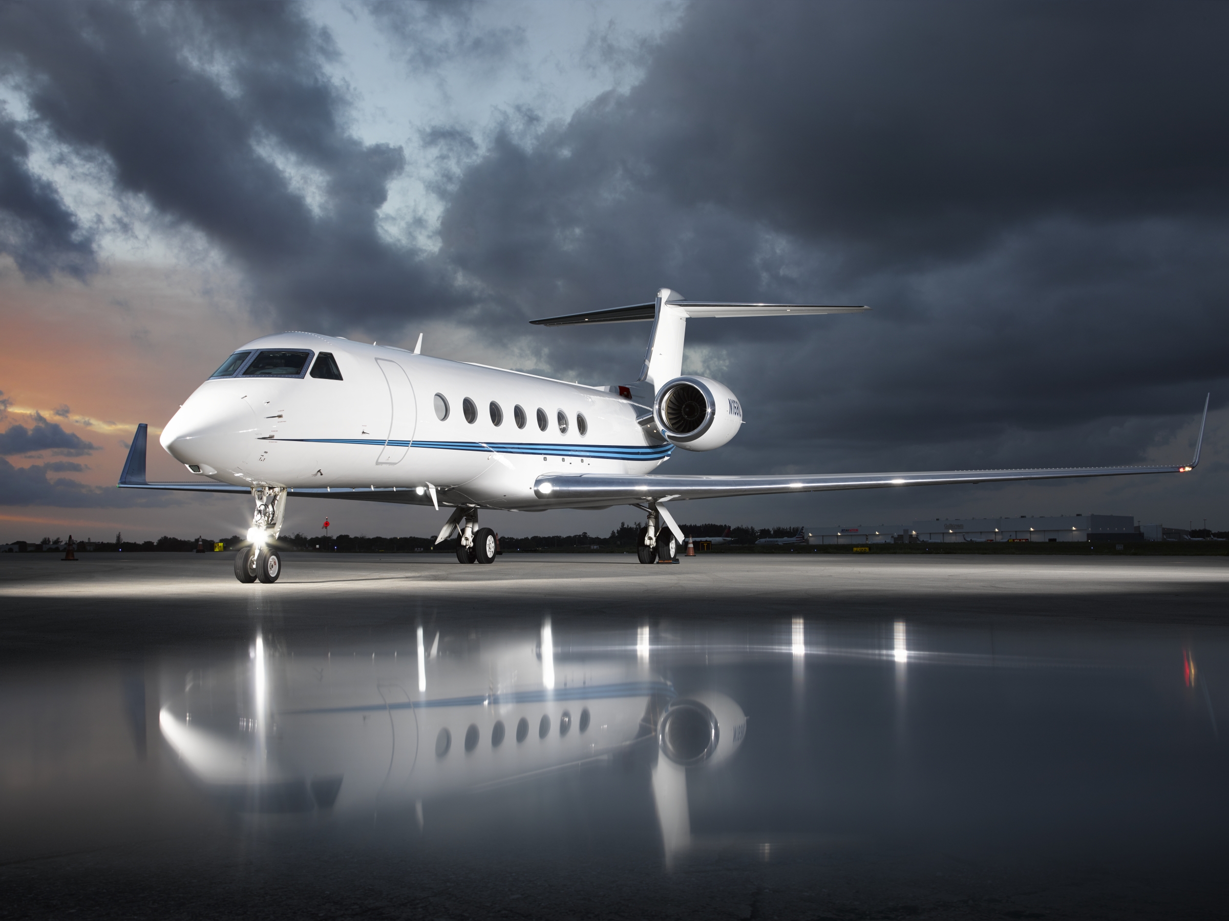 Gulfstream G550 private jet at sunset on a reflective ramp — B&E Aviation Groups worldwide contract pilot and mentor pilot network